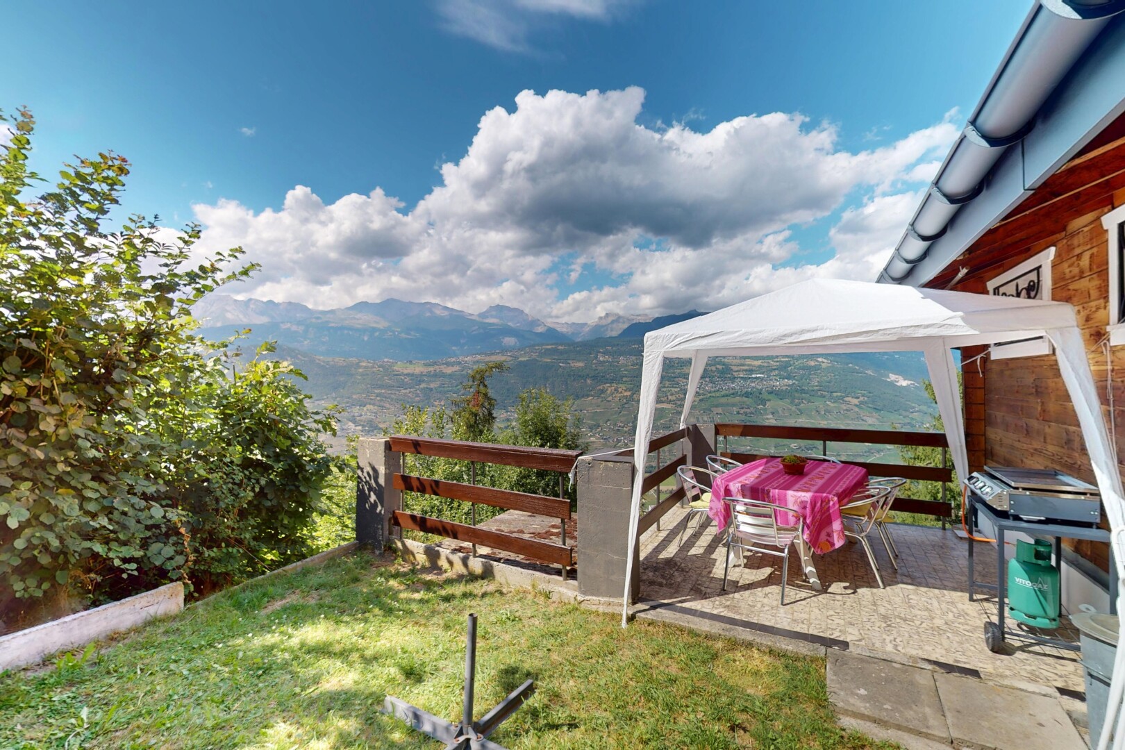 garden featuring a gazebo, a mountain view, a yard, and a grill