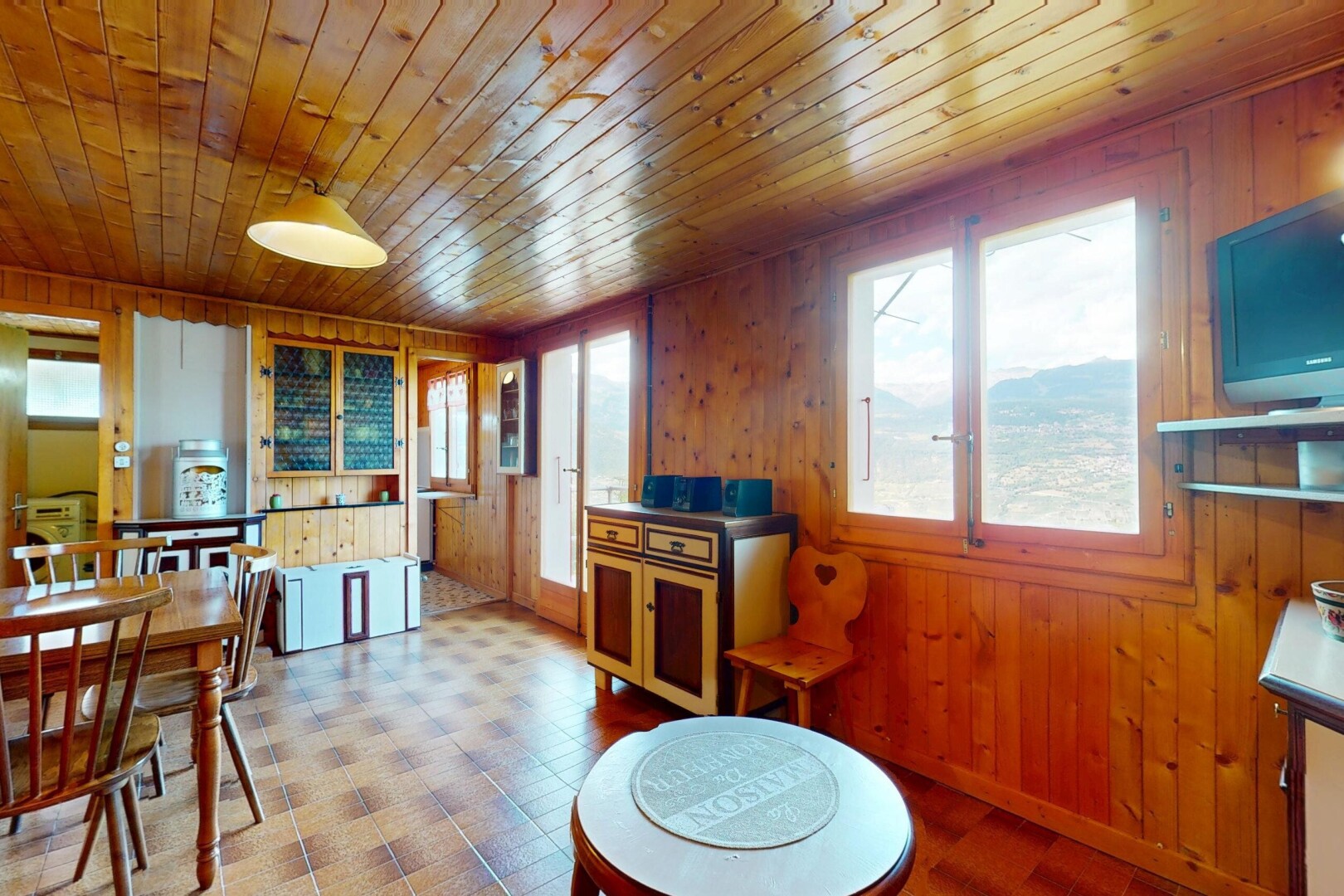 dining room featuring wooden walls, plenty of natural light, wood ceiling, and tile patterned floors