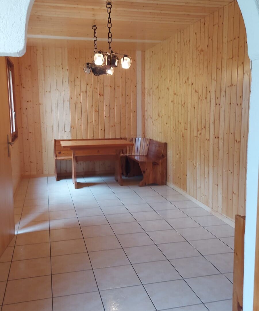 unfurnished room featuring wooden walls, tile patterned floors, and a sauna / steam room