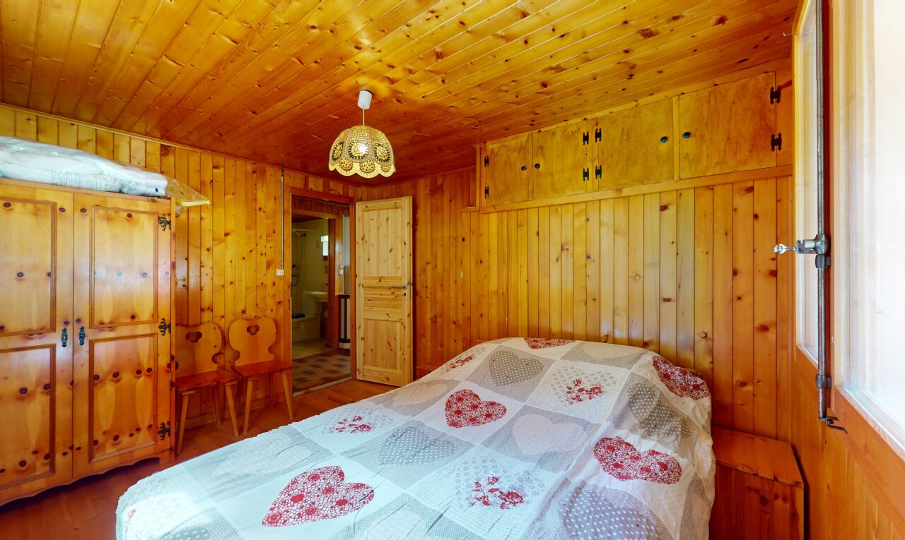 room / bedroom featuring wood finished floors, wood walls, and wood ceiling