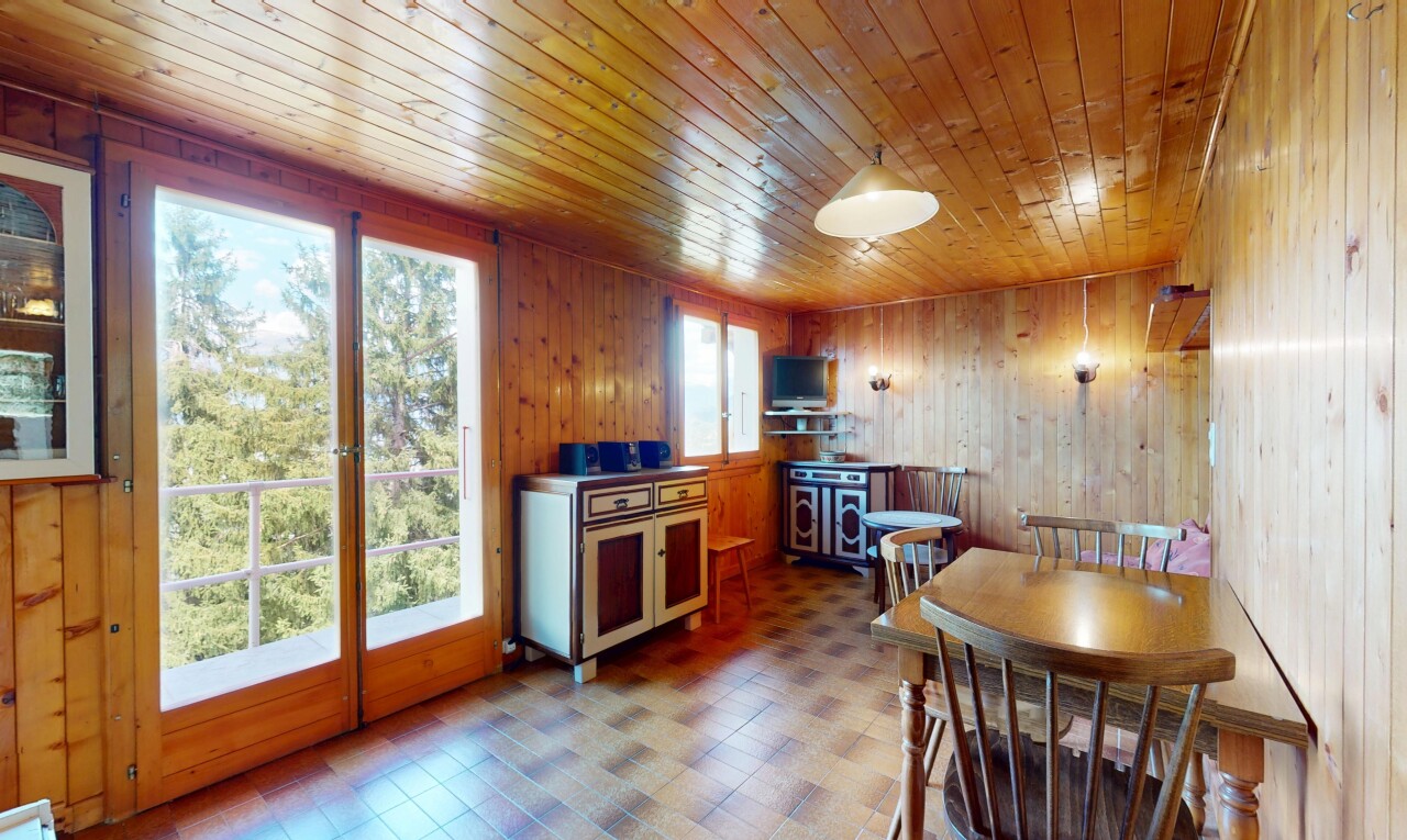 dining area with wood walls, wooden ceiling, and tile patterned floors