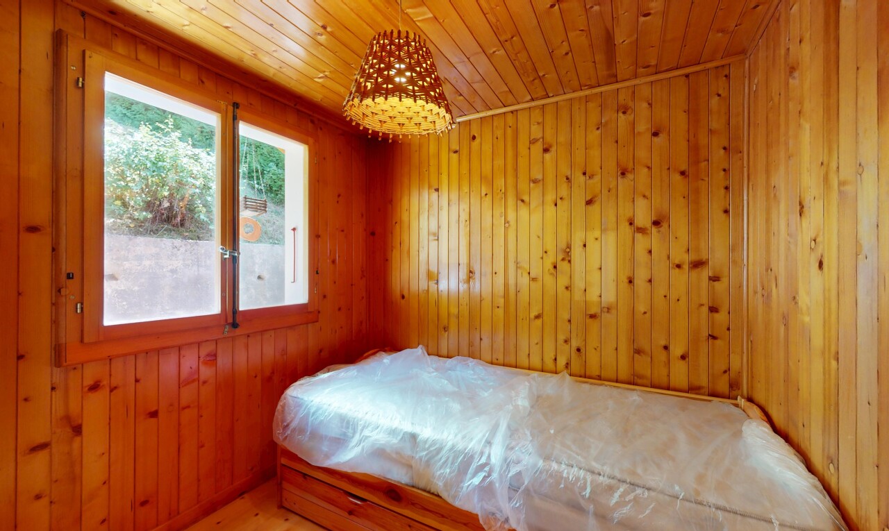 room / bedroom featuring wood walls and wooden ceiling