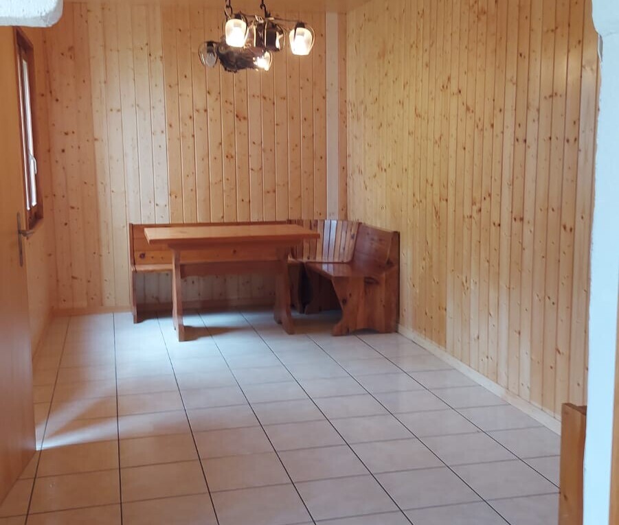 unfurnished room featuring wooden walls, tile patterned floors, and a sauna / steam room