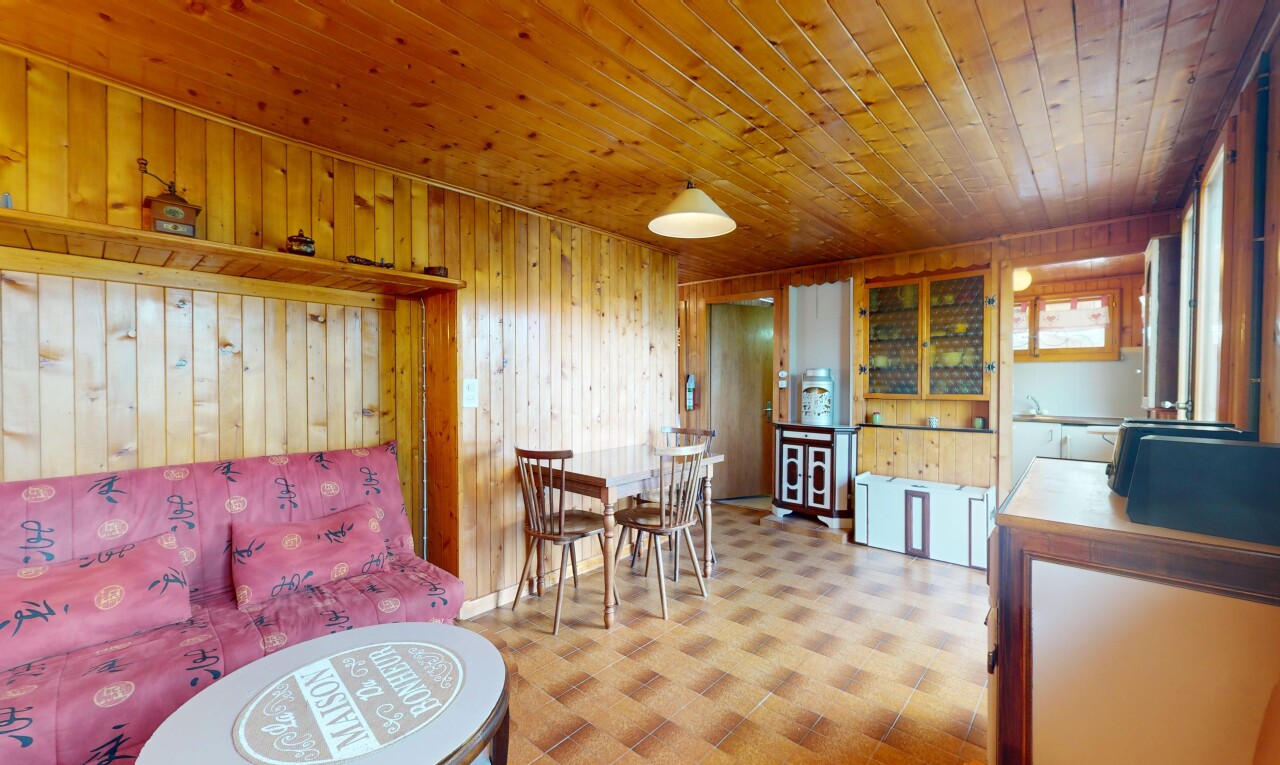 living room featuring wooden walls, tile patterned floors, and wooden ceiling