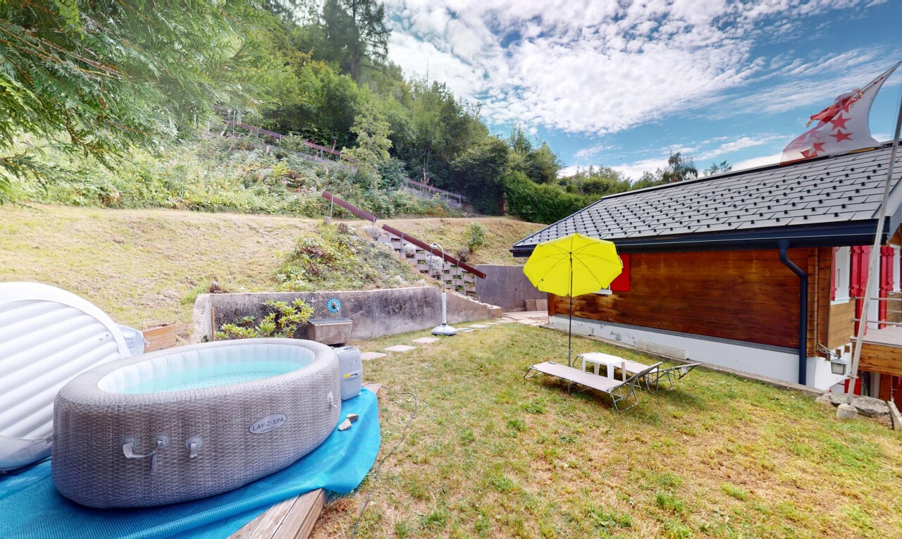 garden with a lawn and a hot tub
