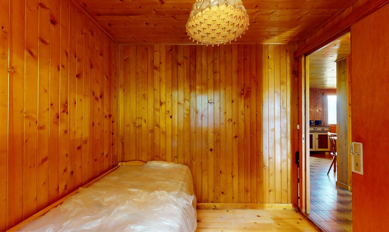 unfurnished room with hardwood / wood-style floors, wood ceiling, and wooden walls