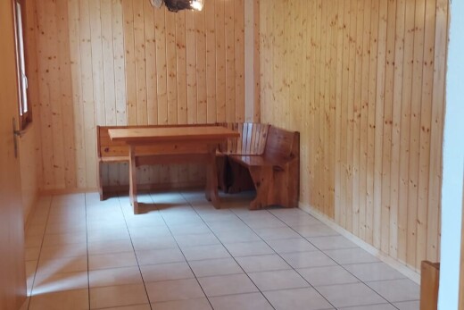unfurnished room featuring wooden walls, tile patterned floors, and a sauna / steam room