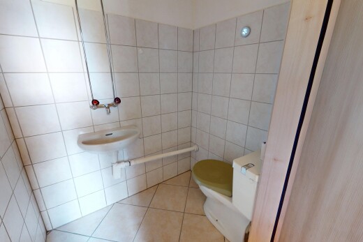 half bath featuring tile patterned flooring and tile walls
