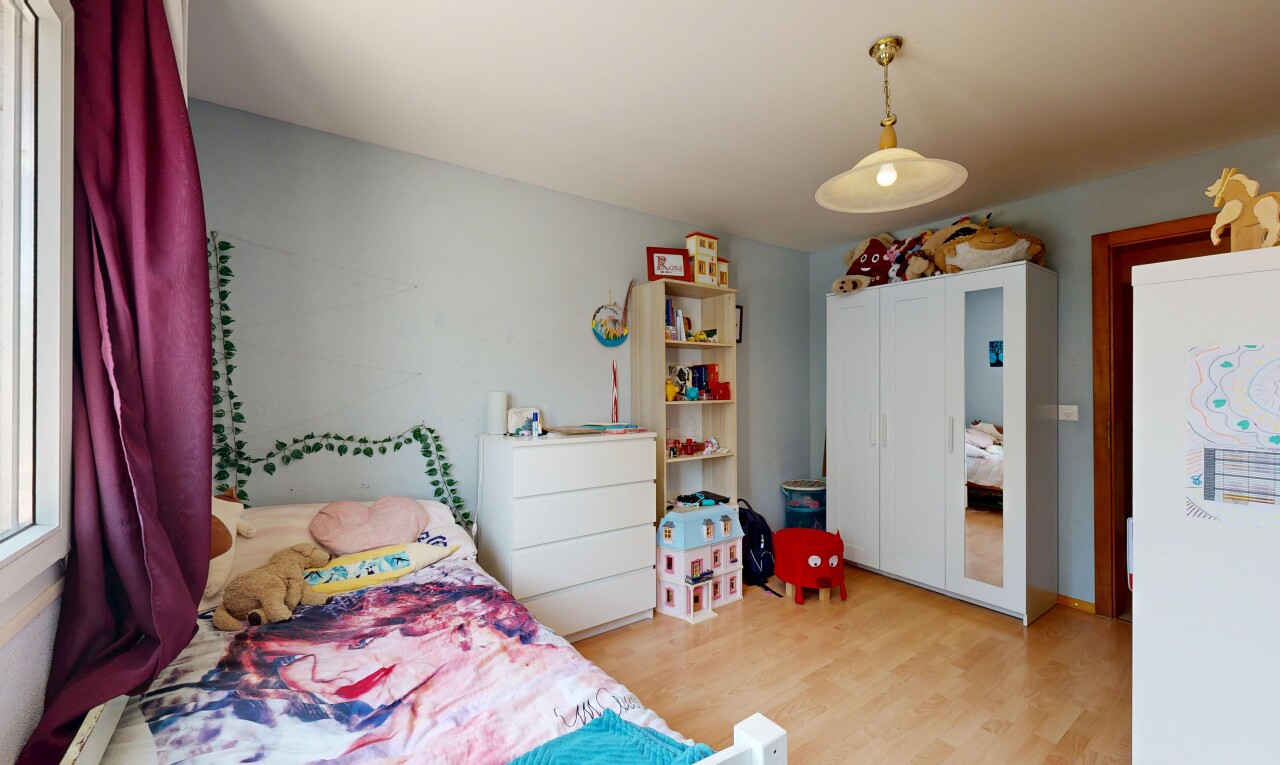 chambre avec éclairage suspendu, wood finish floor, sol en finition bois, drywall, et cloison sèche