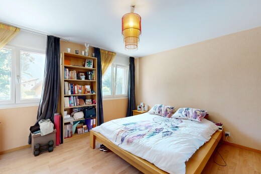 chambre avec lumière naturelle, sol en finition bois, wood finish floor, plinthes murales, et baseboards wall