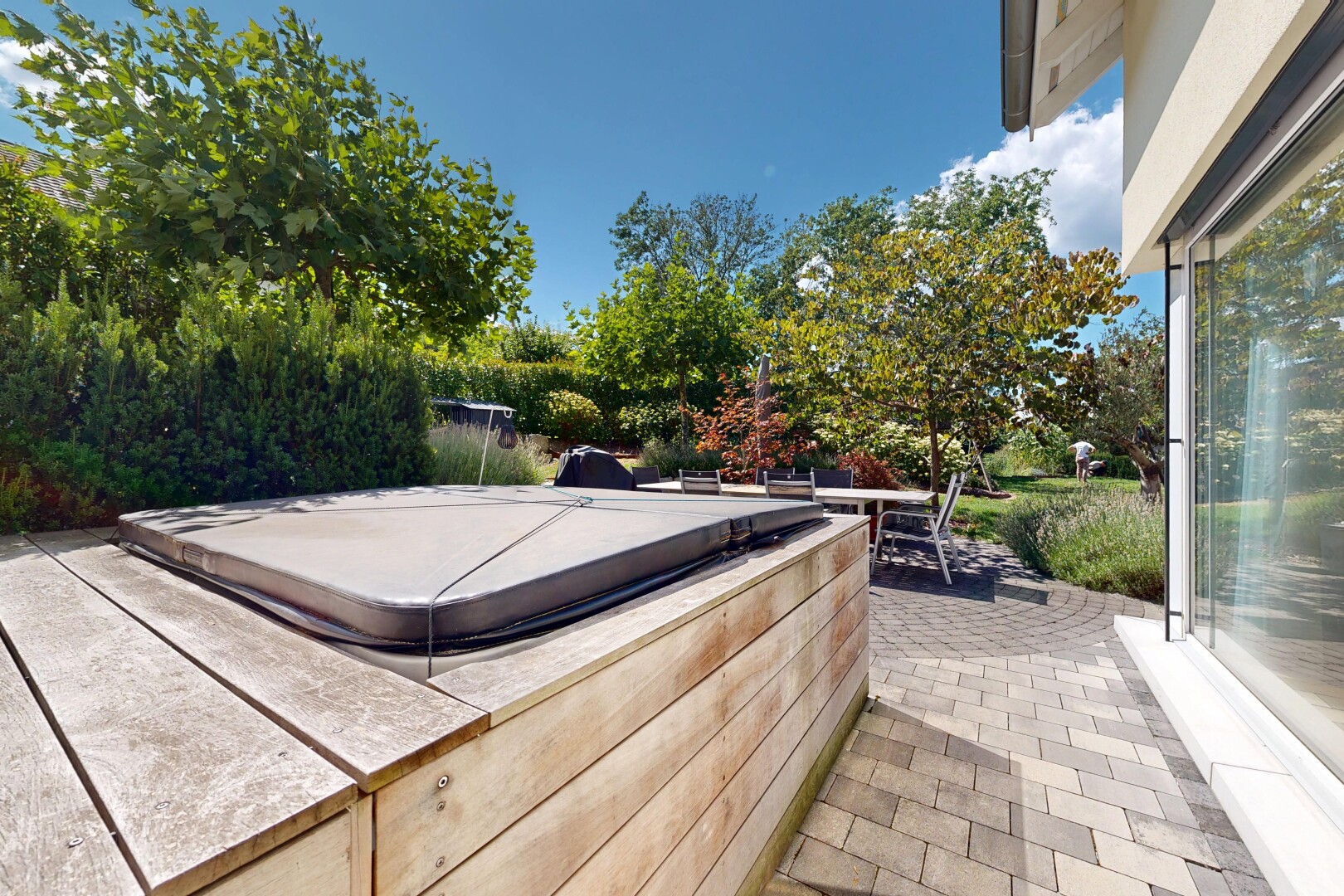 terrace with a hot tub and a patio