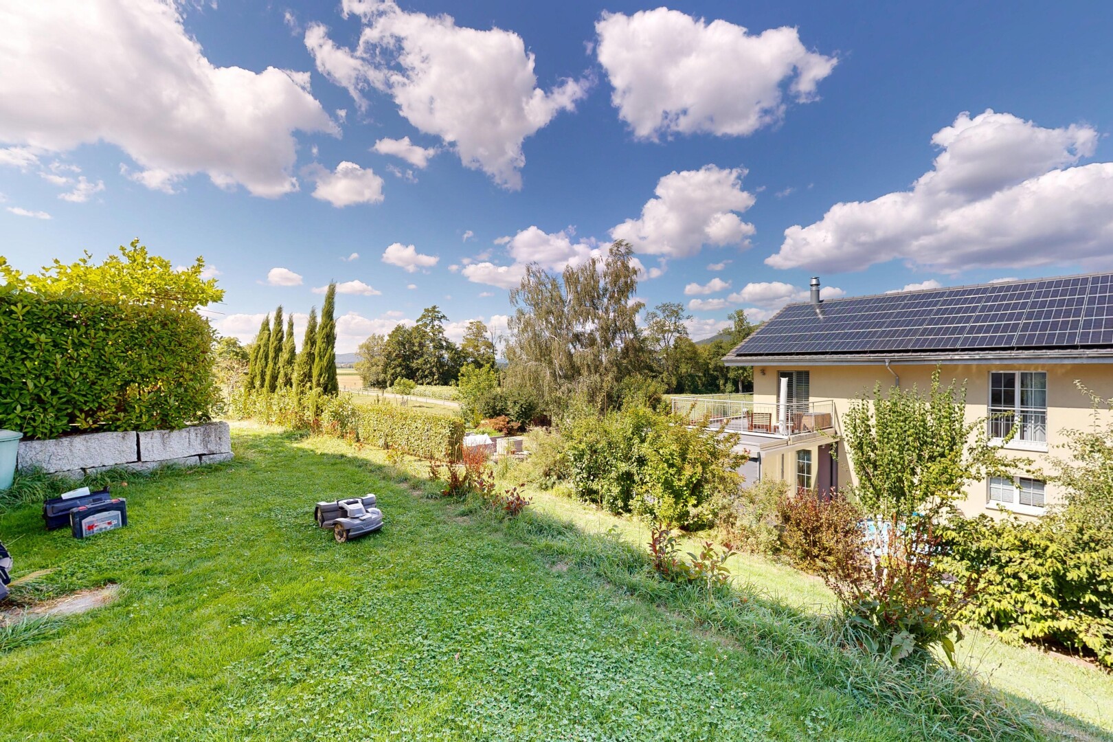 garden with a yard and roof mounted solar panels