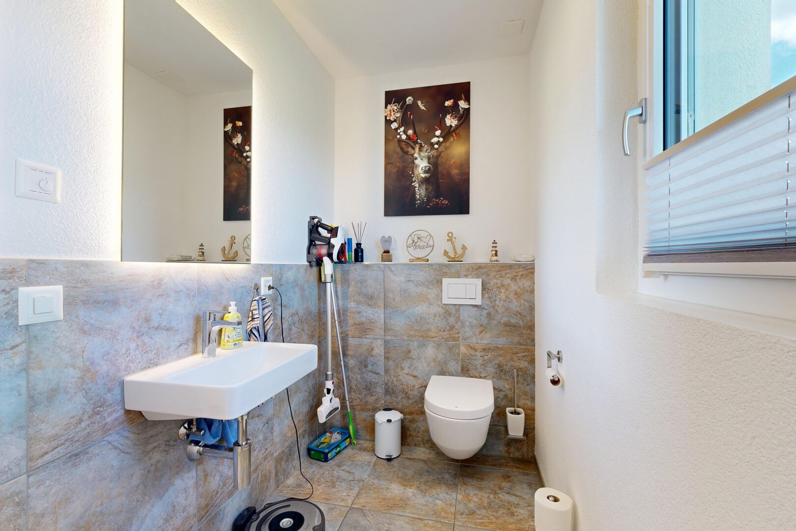 half bathroom with tile walls and a sink