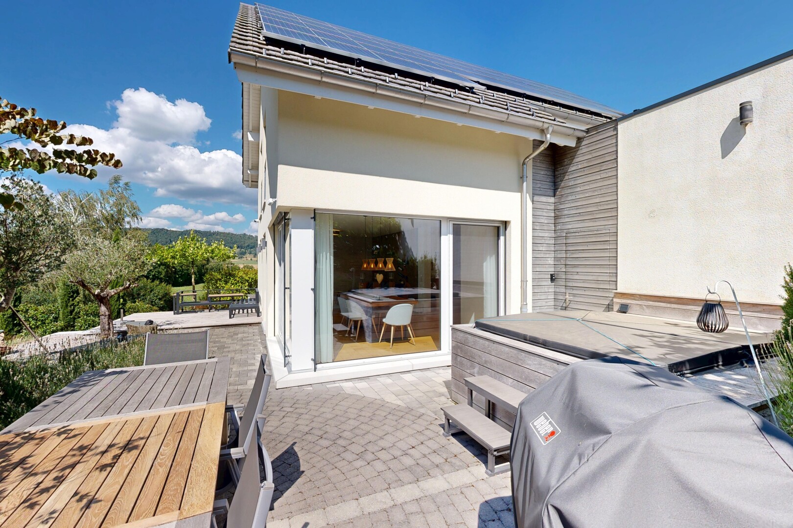 patio / terrace featuring roof mounted solar panels and outdoor dining space
