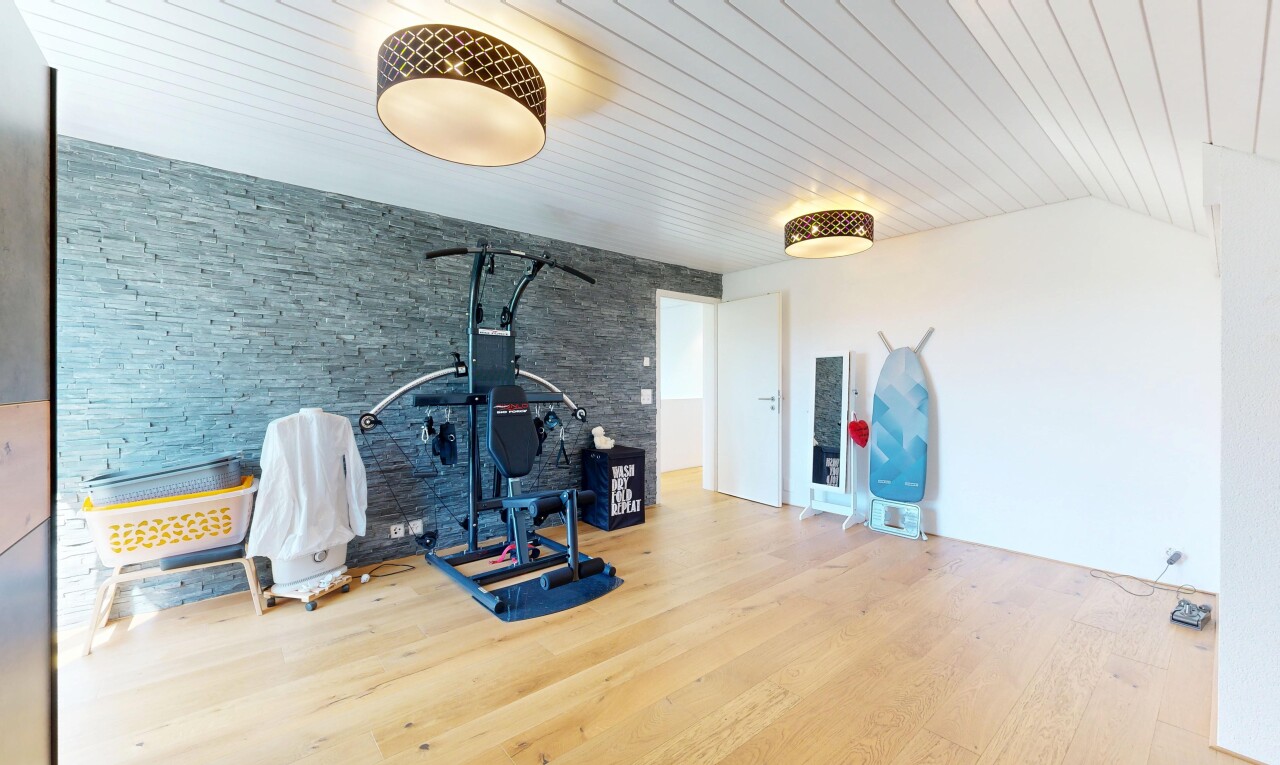 gym with light wood-style flooring, an accent wall, and wooden ceiling