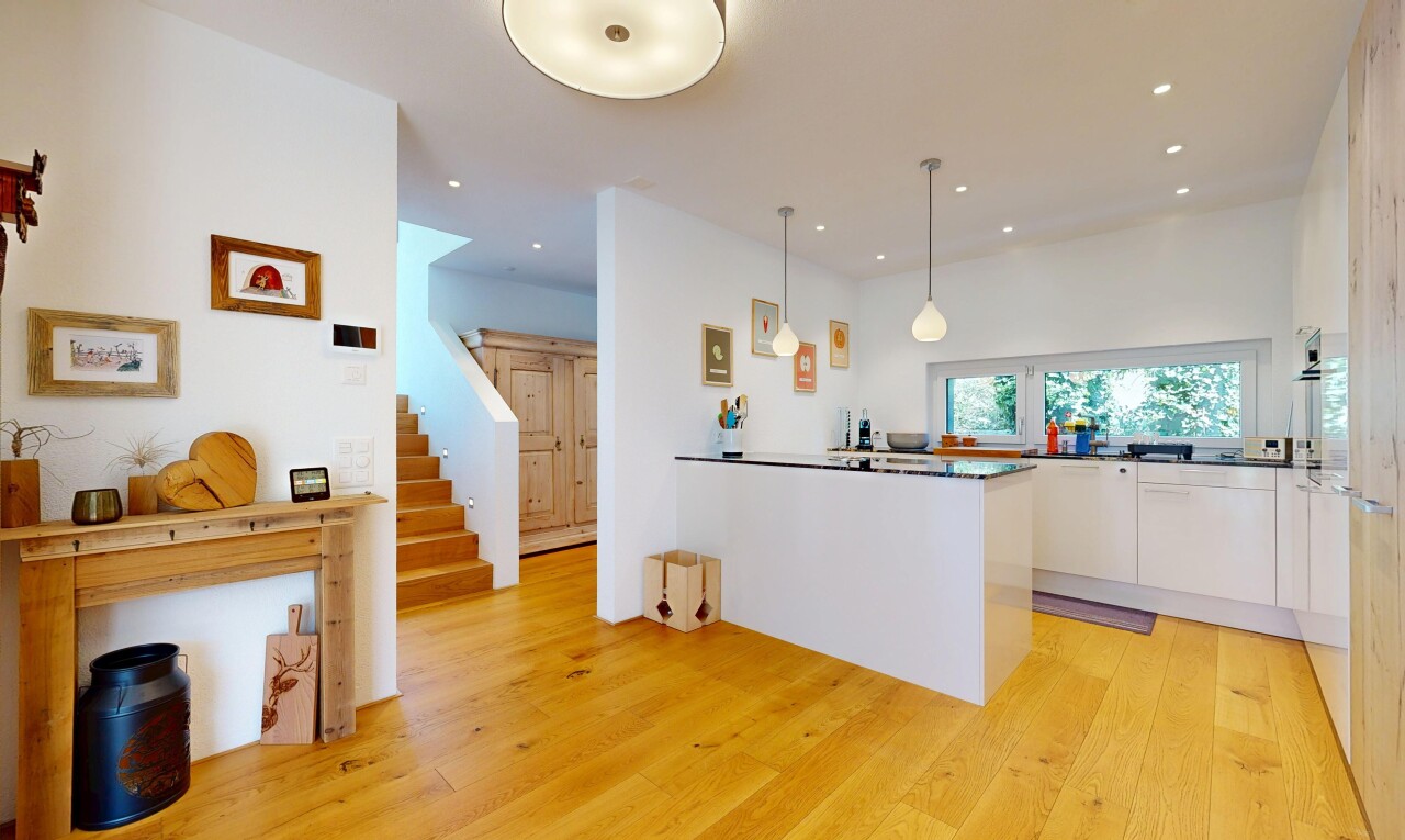 kitchen with hanging light fixtures, white cabinetry, light wood-style floors, a peninsula, and dark countertops