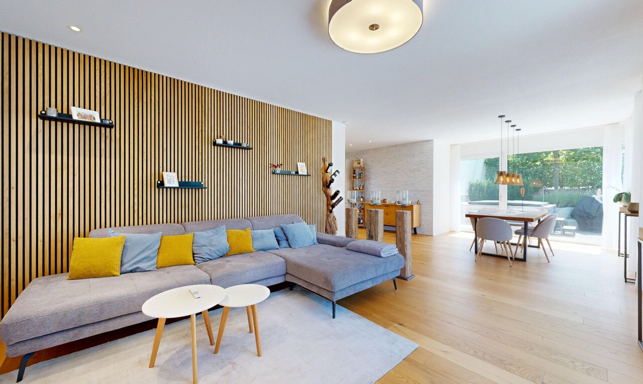 living room with light wood-type flooring and decorative light fixtures