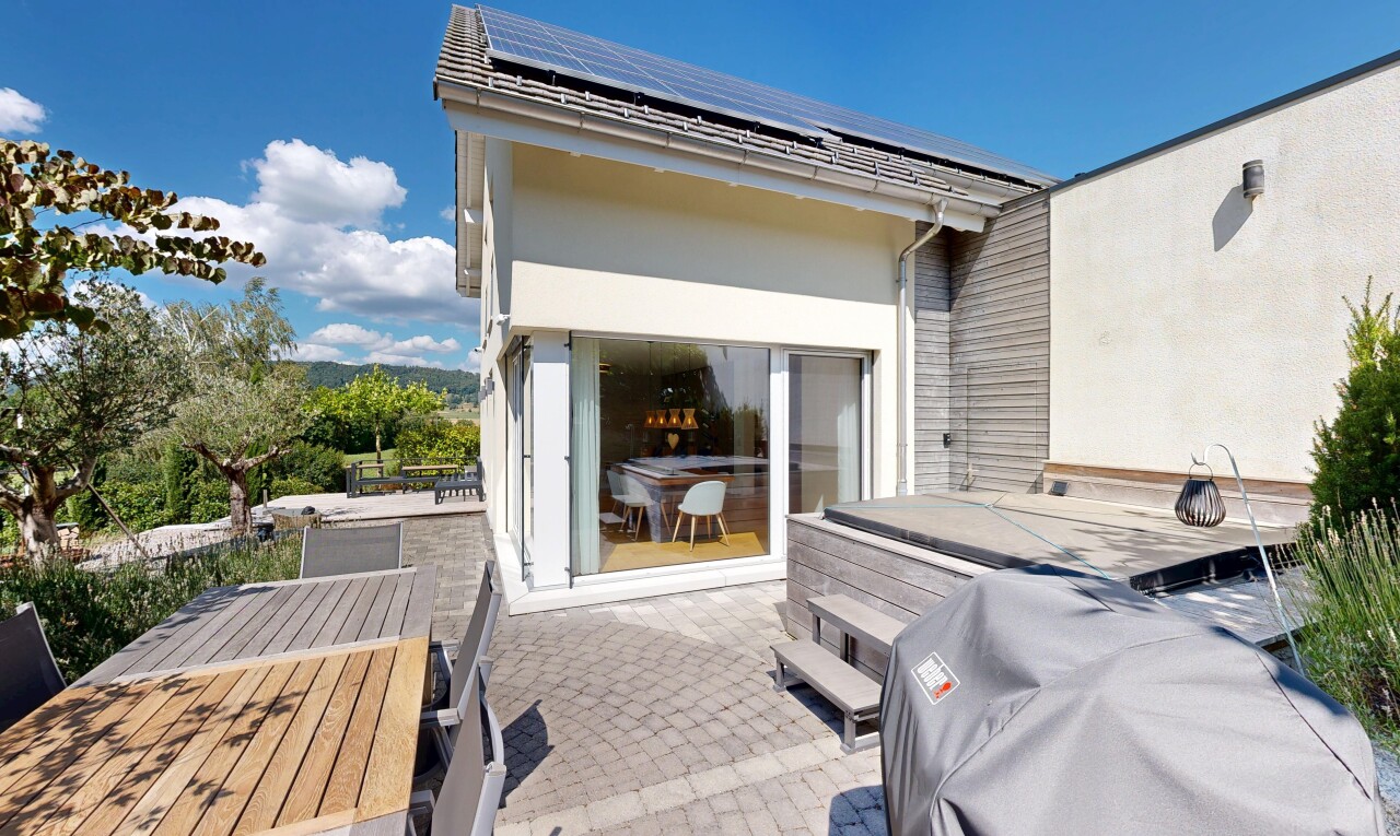 patio / terrace featuring roof mounted solar panels and outdoor dining space
