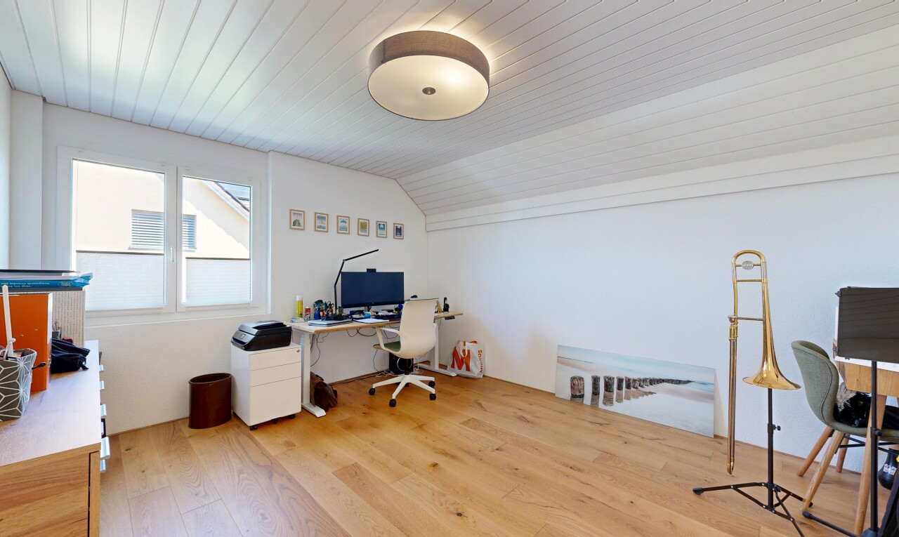 office space featuring vaulted ceiling and light wood-style flooring