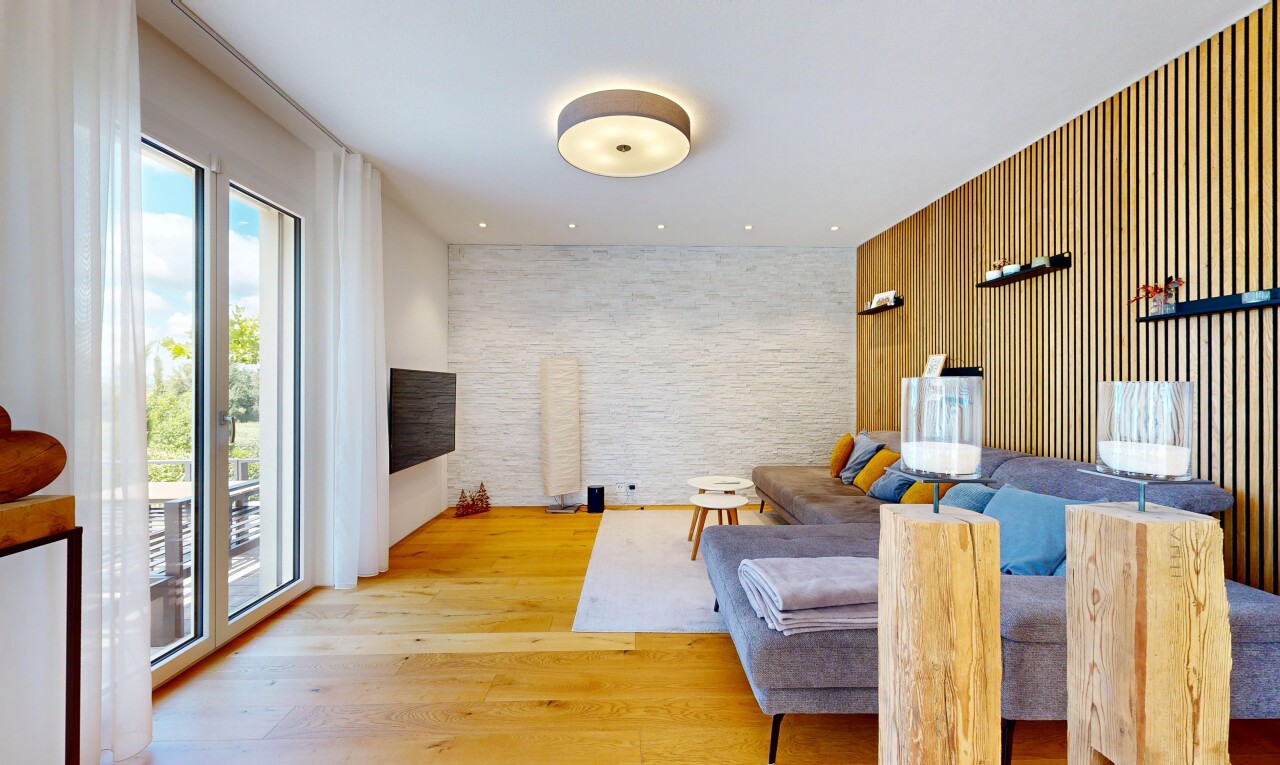 living area with an accent wall, light wood-type flooring, and wooden walls