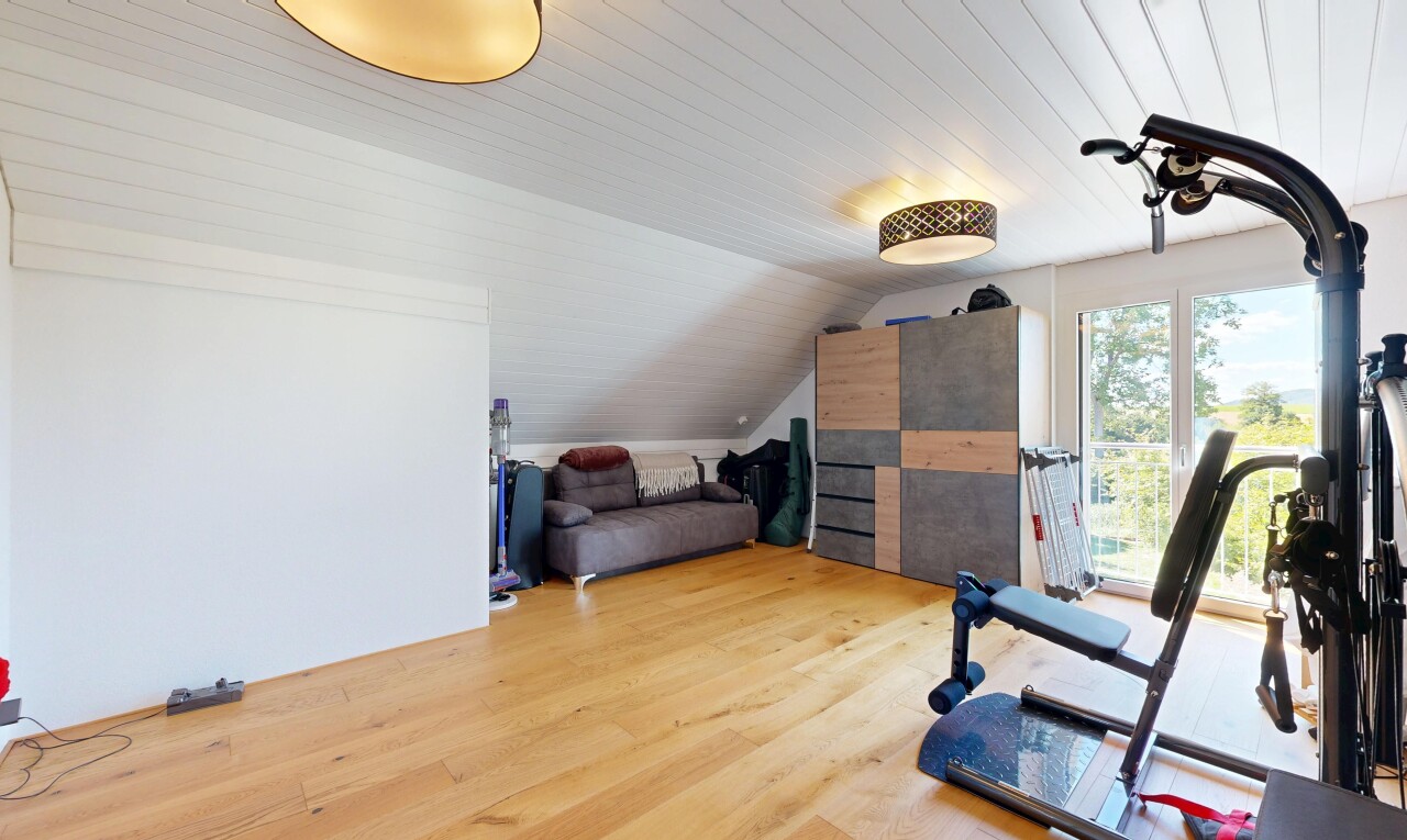 gym with light wood-type flooring and vaulted ceiling
