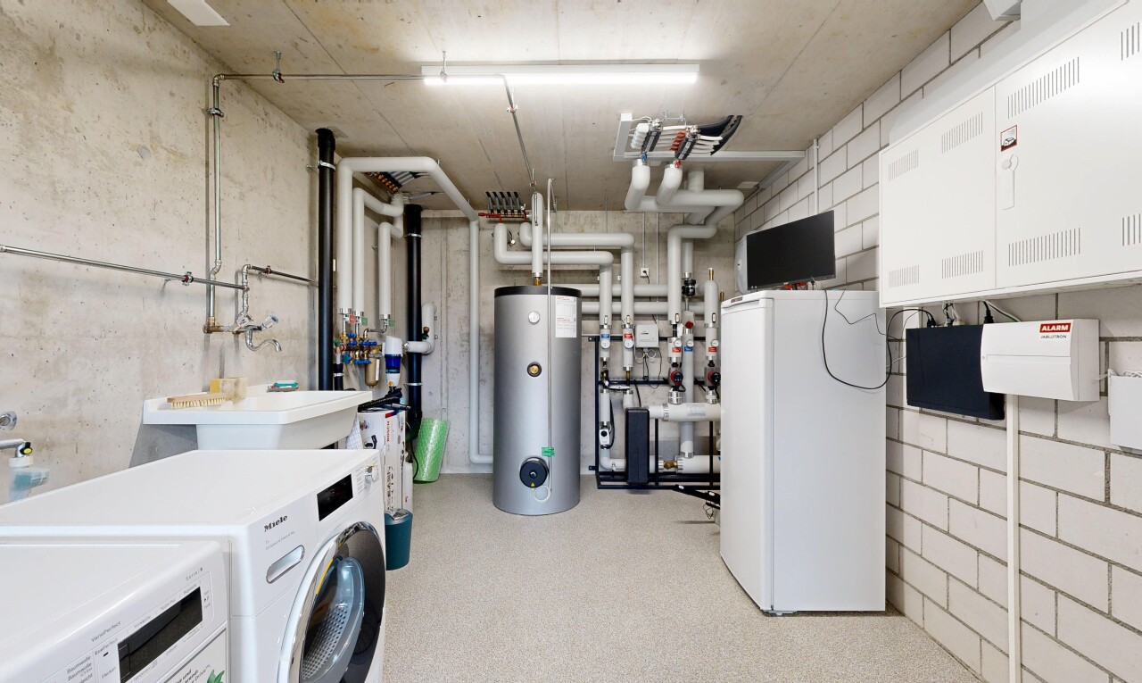 laundry area with water heater and washer and clothes dryer