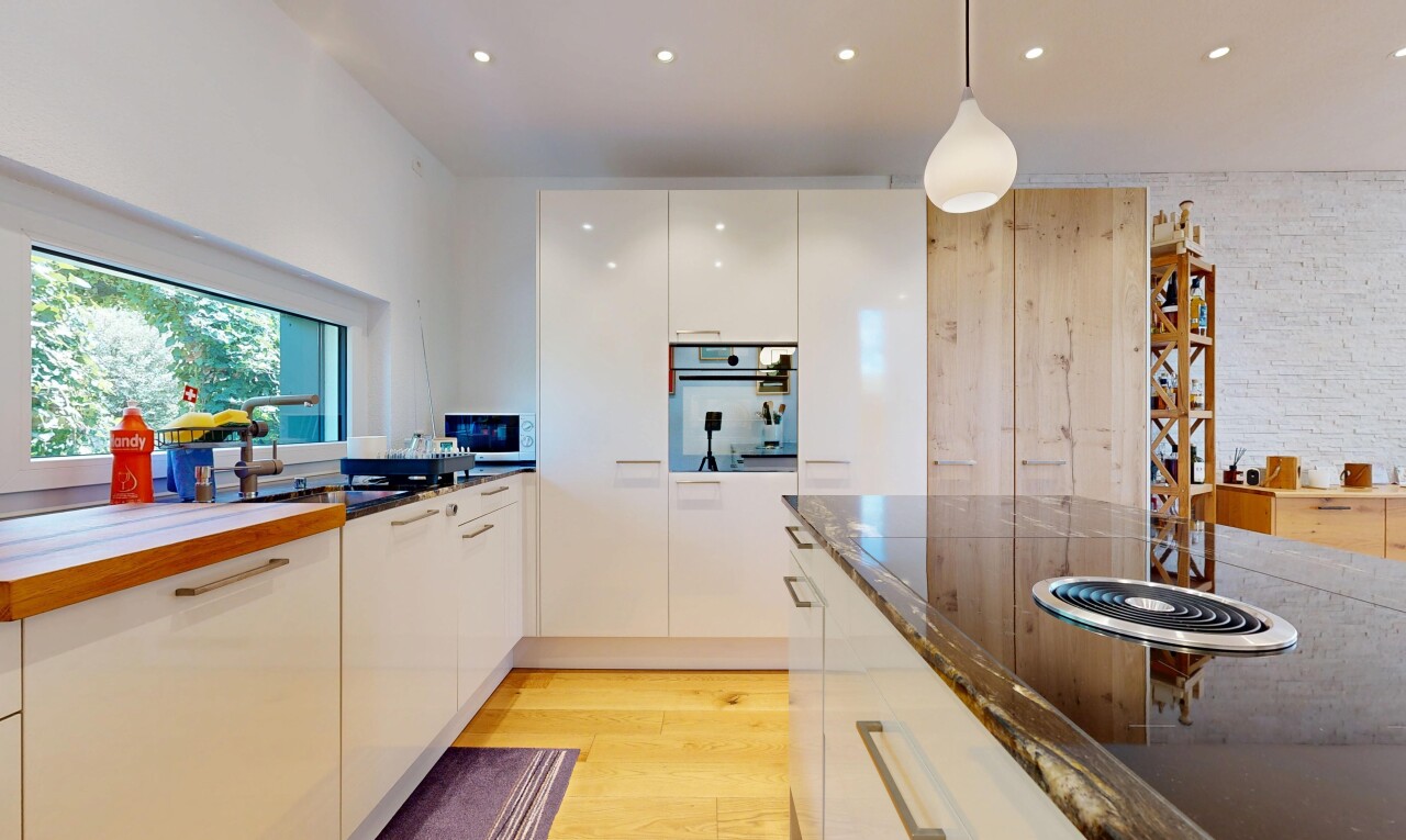 kitchen with light wood finished floors, black electric cooktop, oven, white cabinets, and pendant lighting