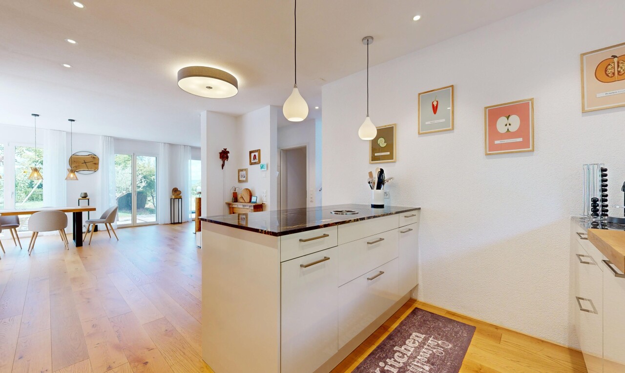 kitchen with pendant lighting, light wood-style floors, a peninsula, dark stone countertops, and modern cabinets
