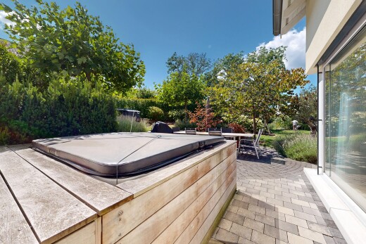 terrace with a hot tub and a patio
