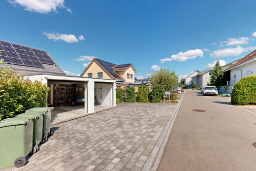 view of property featuring a residential view and decorative driveway