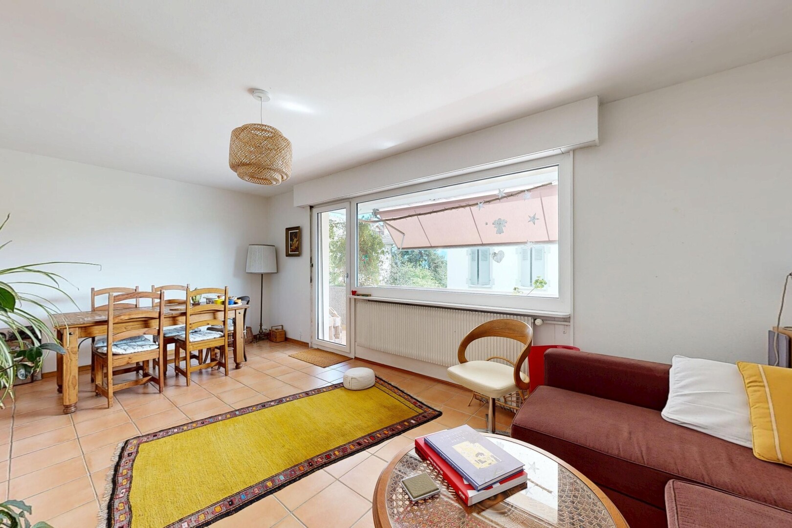 living / dining area featuring light tile patterned floors and radiator