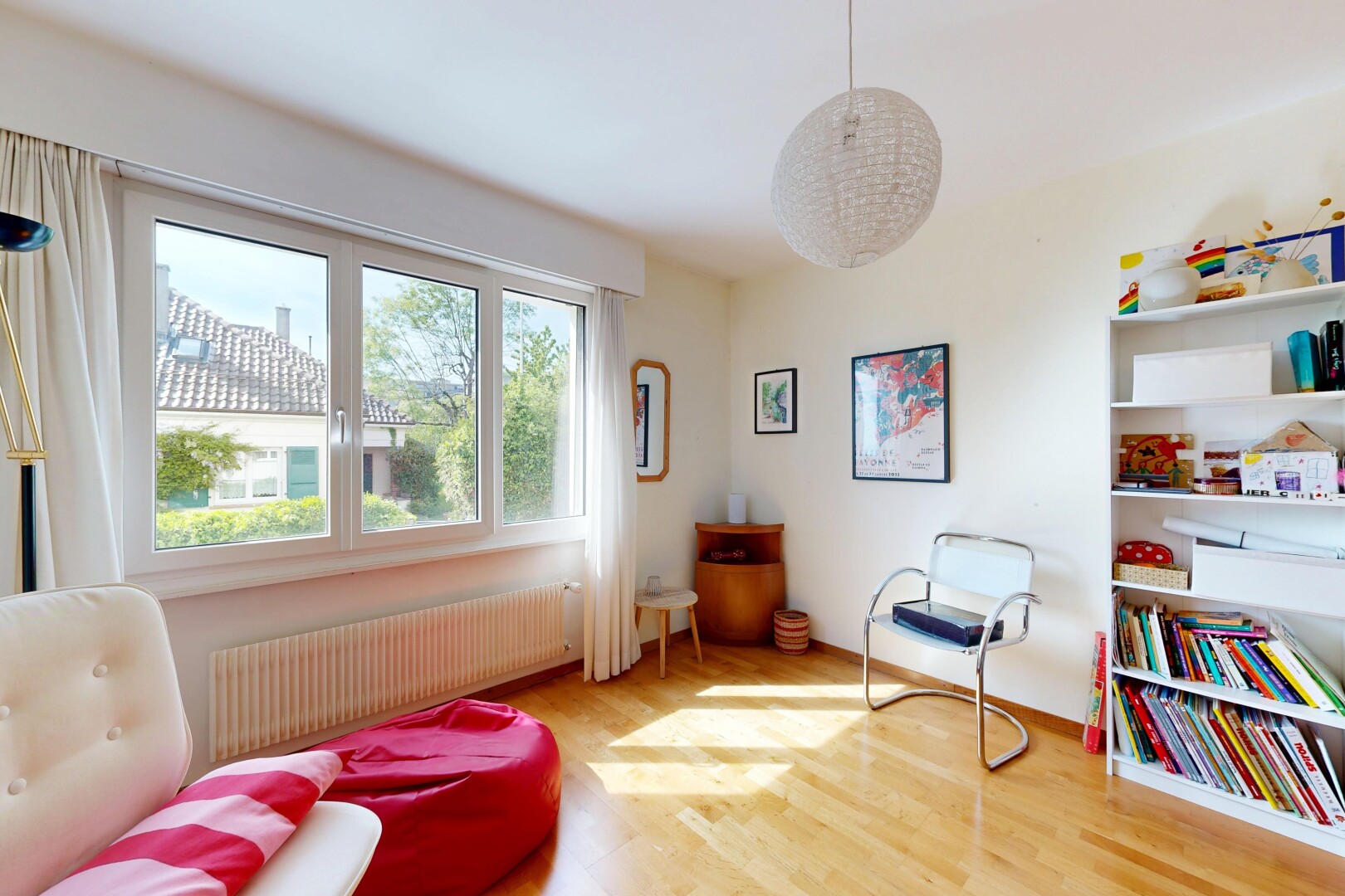 living area featuring radiator heating unit and light wood-style flooring