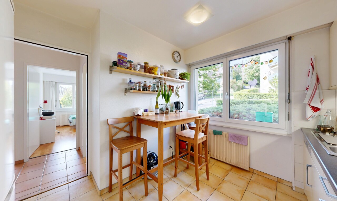 kitchen with radiator and light tile patterned floors