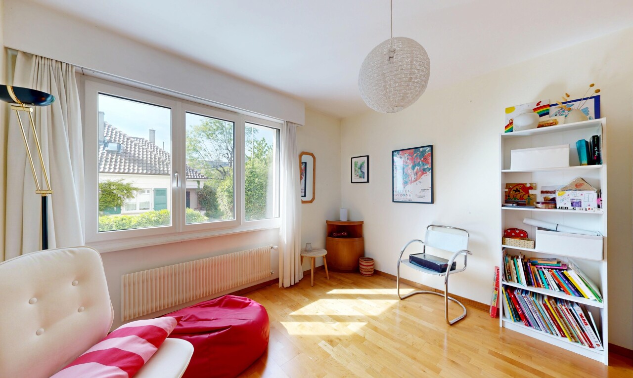 living area featuring radiator heating unit and light wood-style flooring