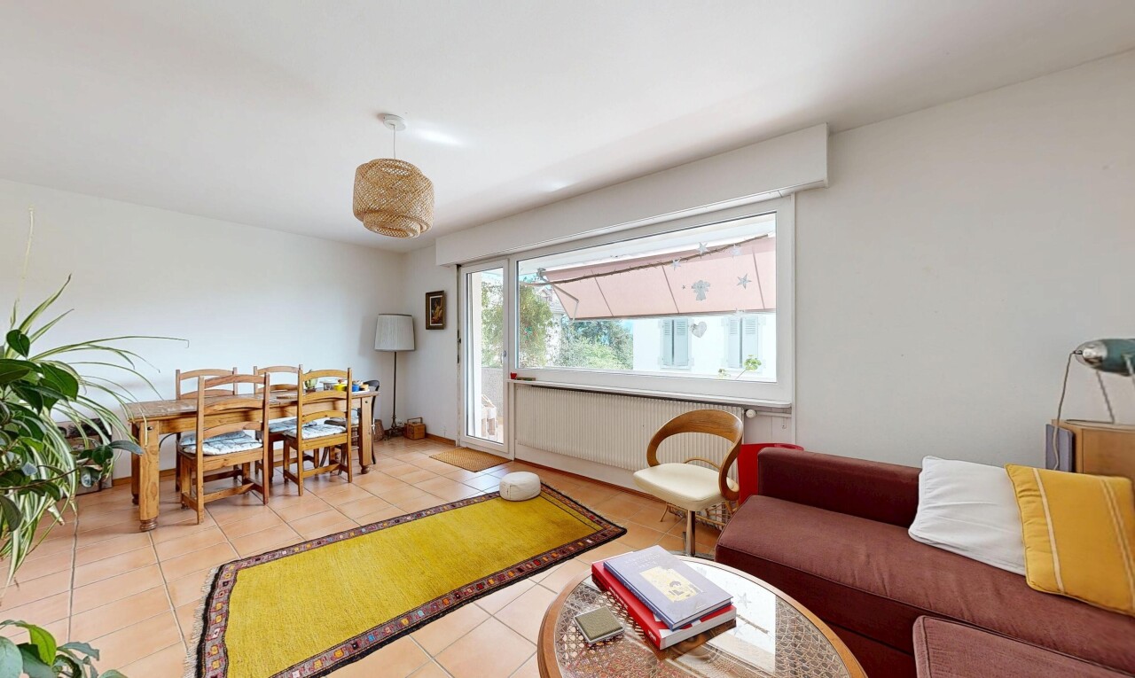 living / dining area featuring light tile patterned floors and radiator