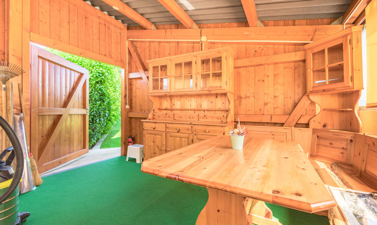 unfurnished dining room featuring wooden walls