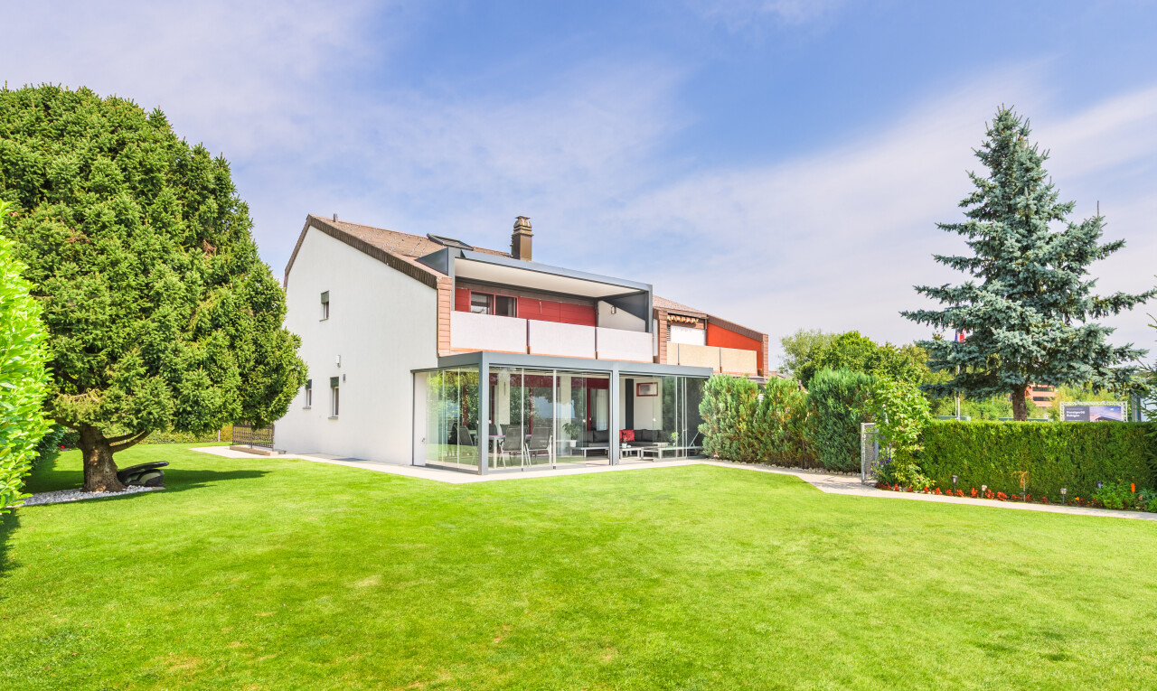view of home featuring a yard and a chimney