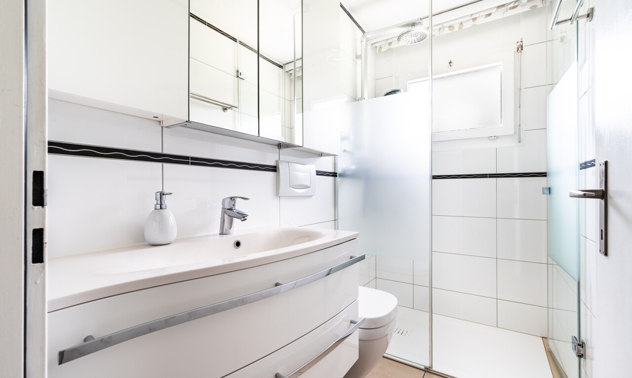 bathroom featuring vanity, a shower stall, and light tile patterned floors