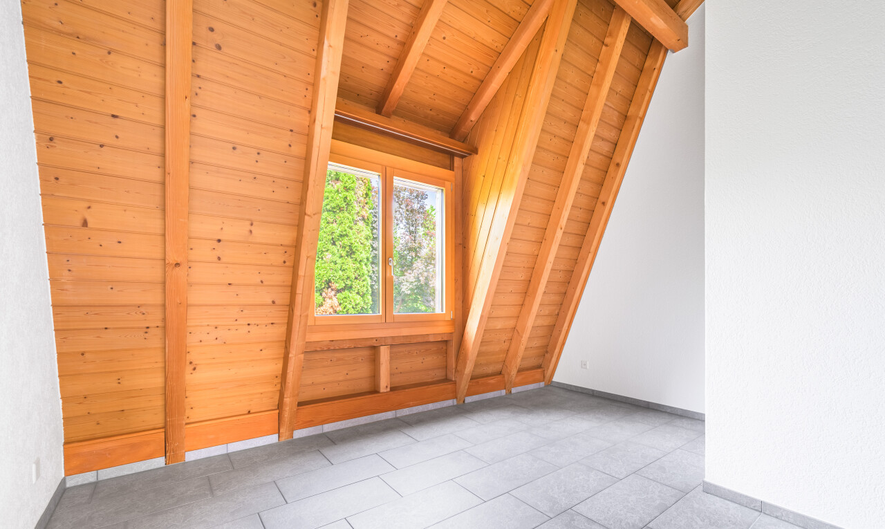 tiled empty room featuring wood ceiling and baseboards