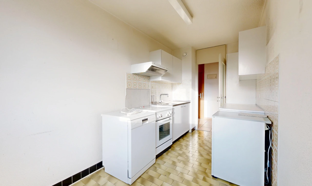 kitchen featuring white appliances, light countertops, white cabinetry, and backsplash