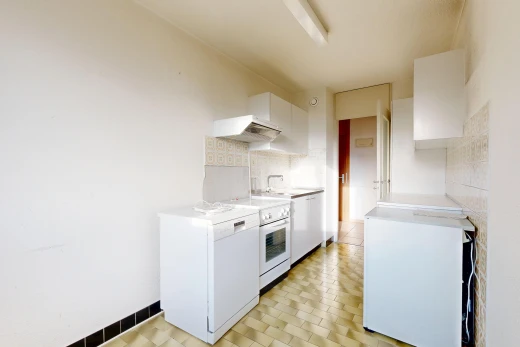 kitchen featuring white appliances, light countertops, white cabinetry, and backsplash
