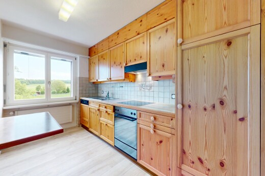 kitchen featuring wall oven, light countertops, backsplash, light wood-style floors, and under cabinet range hood