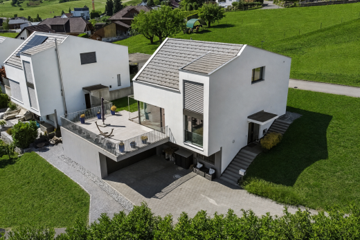 outdoor house with a lawn, stucco siding, an attached garage, and driveway