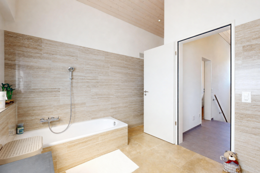 bathroom featuring tile walls, tiled bath, wooden ceiling, and light tile patterned flooring