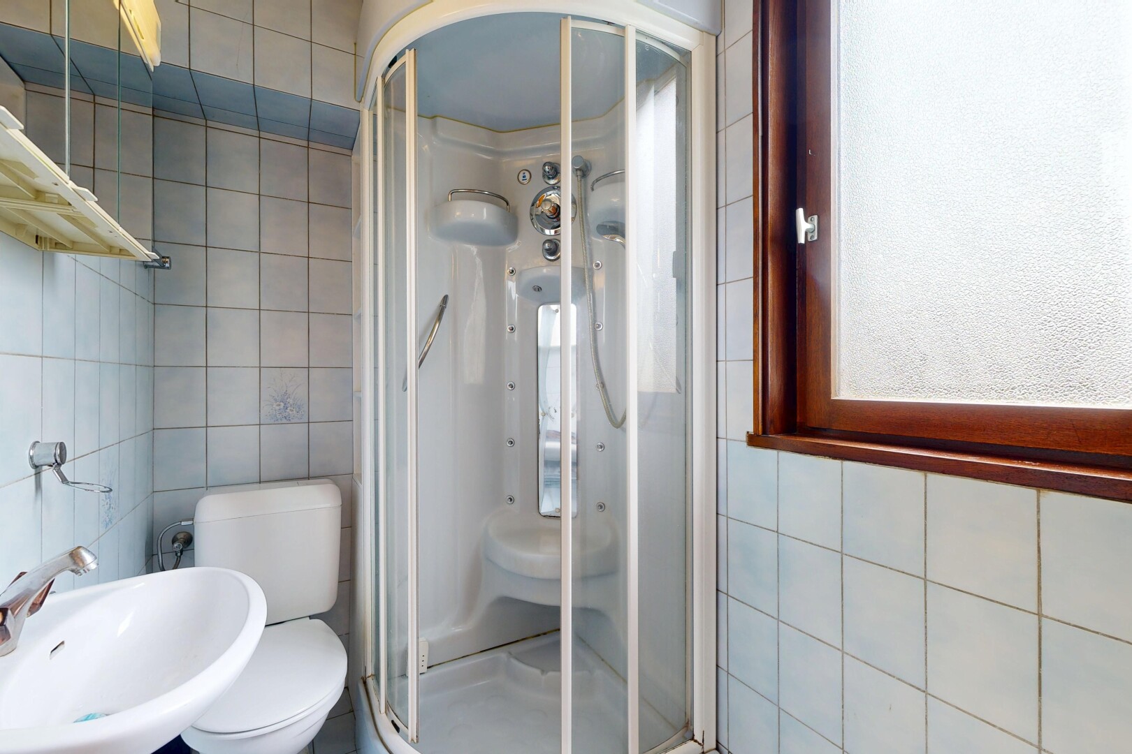 salle de bains avec tile wall, mur en carrelage, inside property, douche, et évier