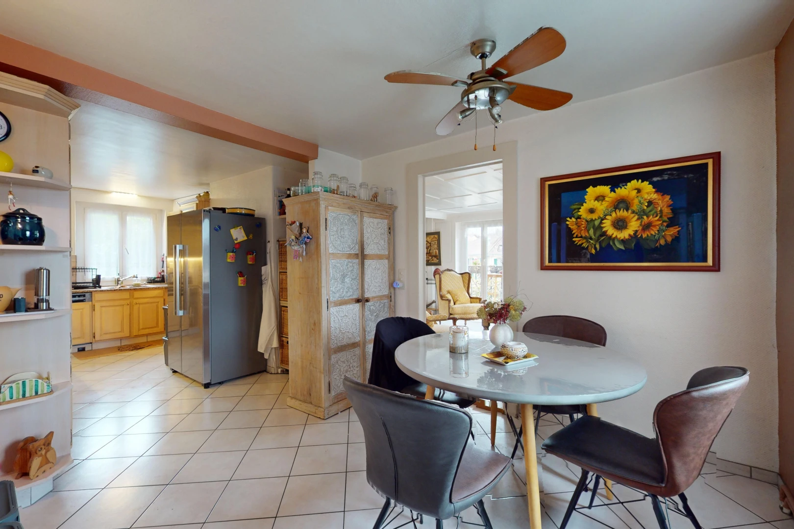 salle à manger avec lumière naturelle, ventilateur de plafond, et carrelage