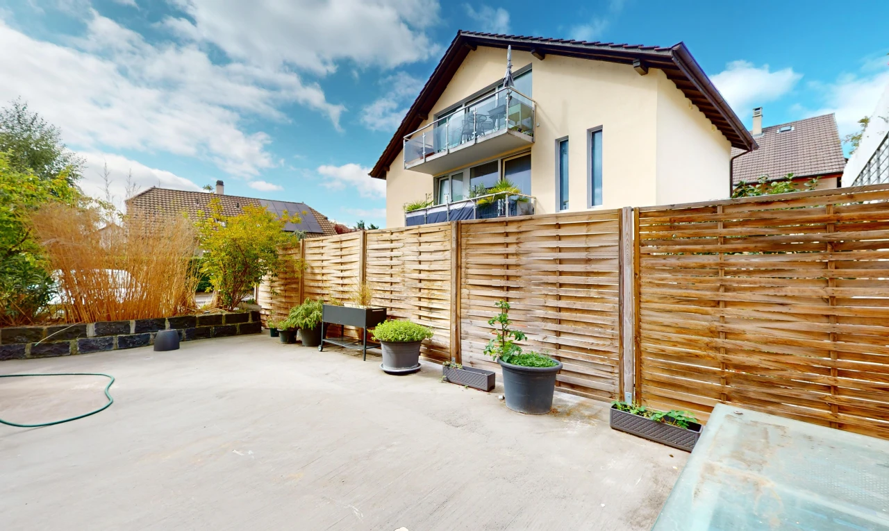 façade avec balcon, clôture, et patio