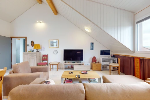 living room featuring beam ceiling and high vaulted ceiling