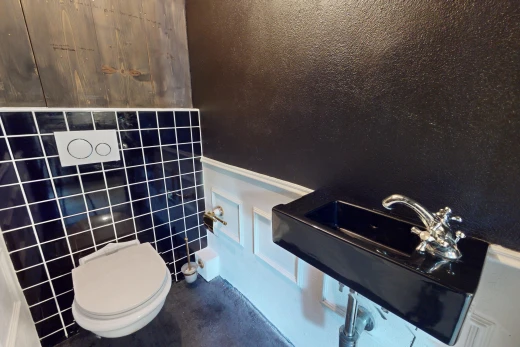 bathroom with tile walls and toilet