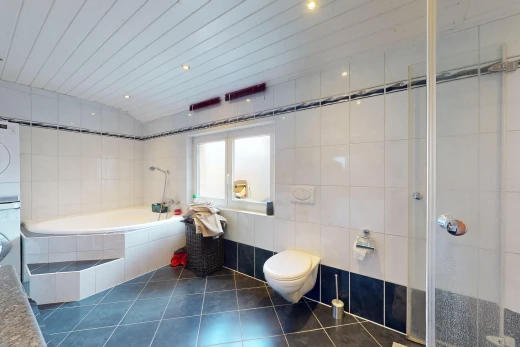 bathroom with tile walls, tile patterned flooring, stacked washer / dryer, independent shower and bath, and toilet
